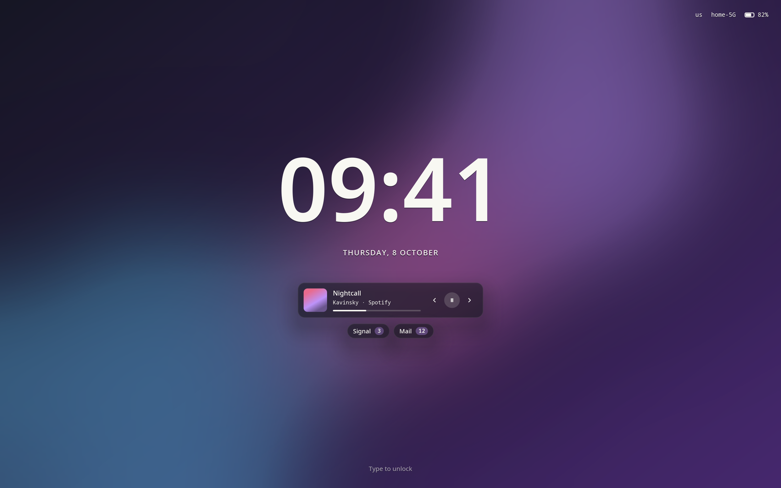 The lock screen at rest: a large clock, the date, a media card and notification counts over the wallpaper
